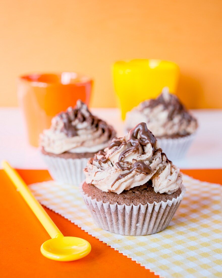 Cupcakes with buttercream and chocolate sauce