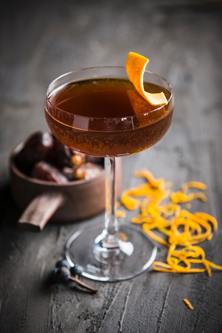 A cocktail with orange peel