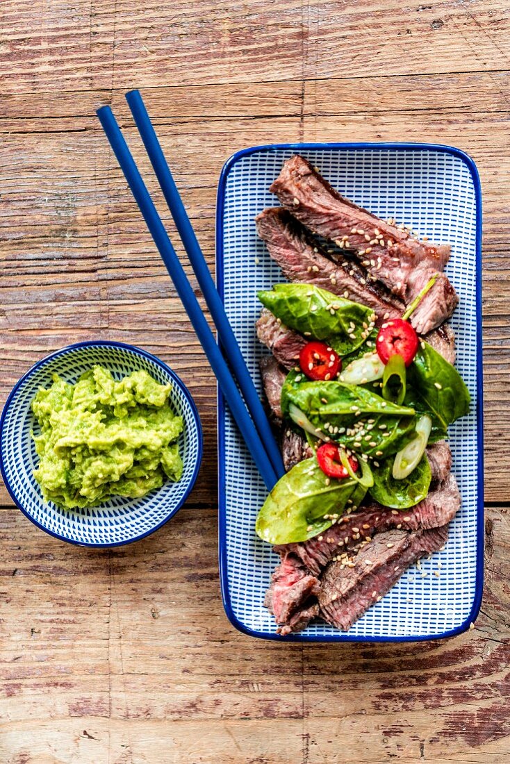 Steak with spinach leaves and a wasabi-avocado dip (Japan)