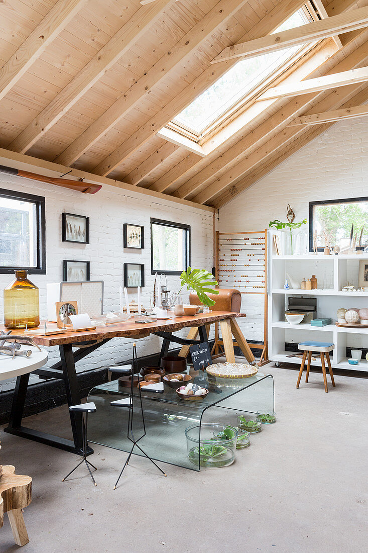 Various furnishings in natural shades in house with exposed roof structure