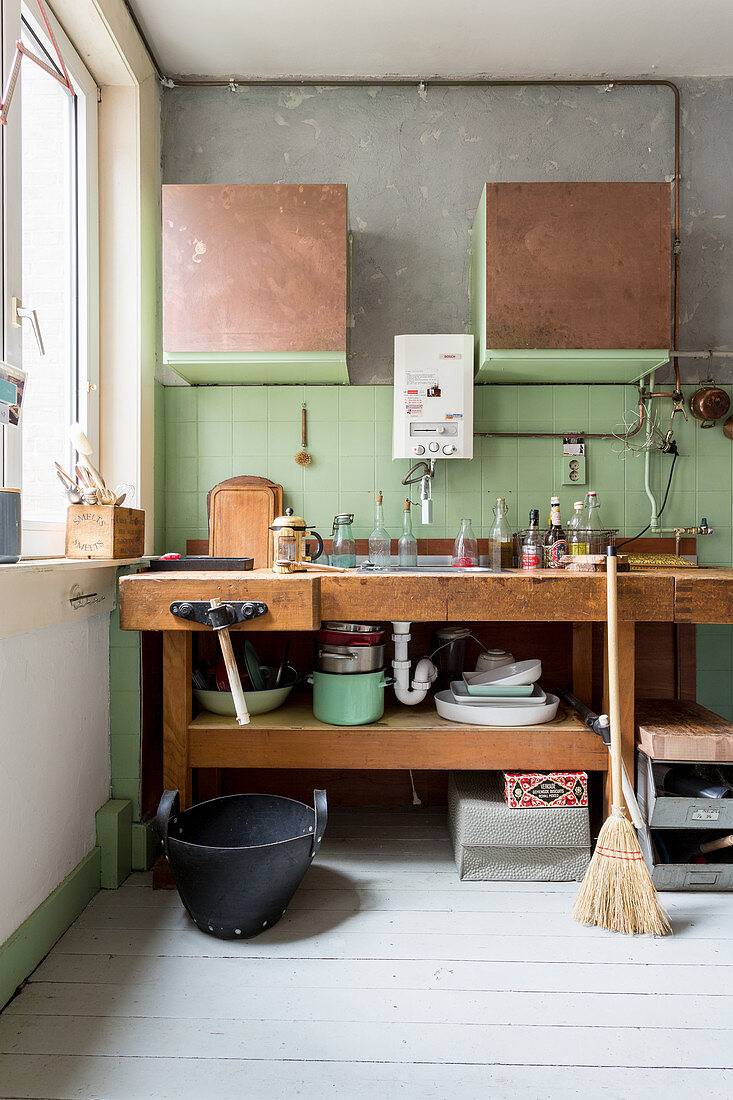 Old workbench used as sink unit in alternative kitchen