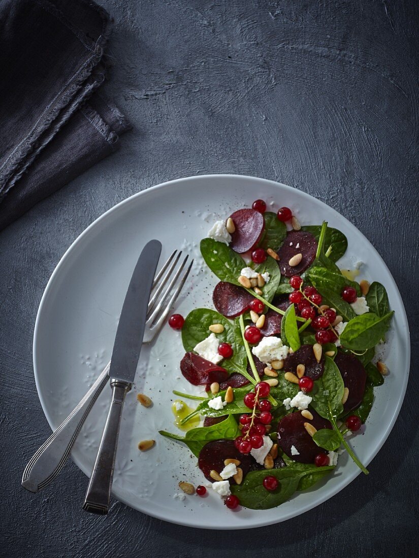 Beetroot salad with baby leaf spinach, feta, redcurrants and pine nuts