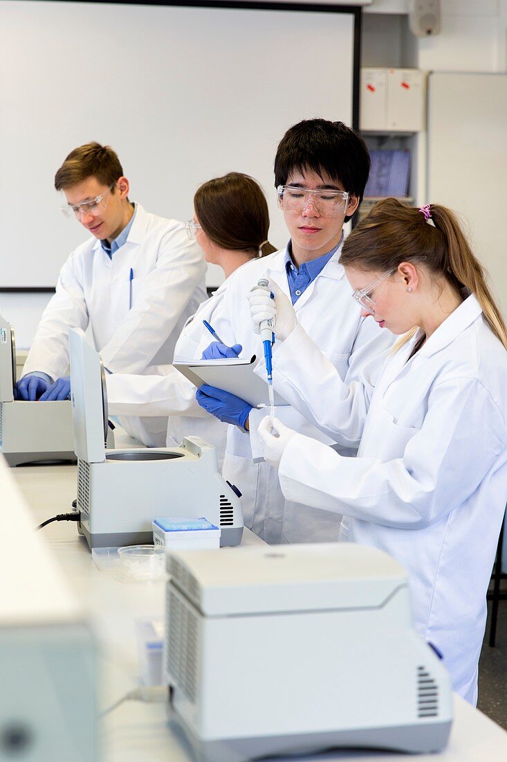 Chemistry students using centrifuges