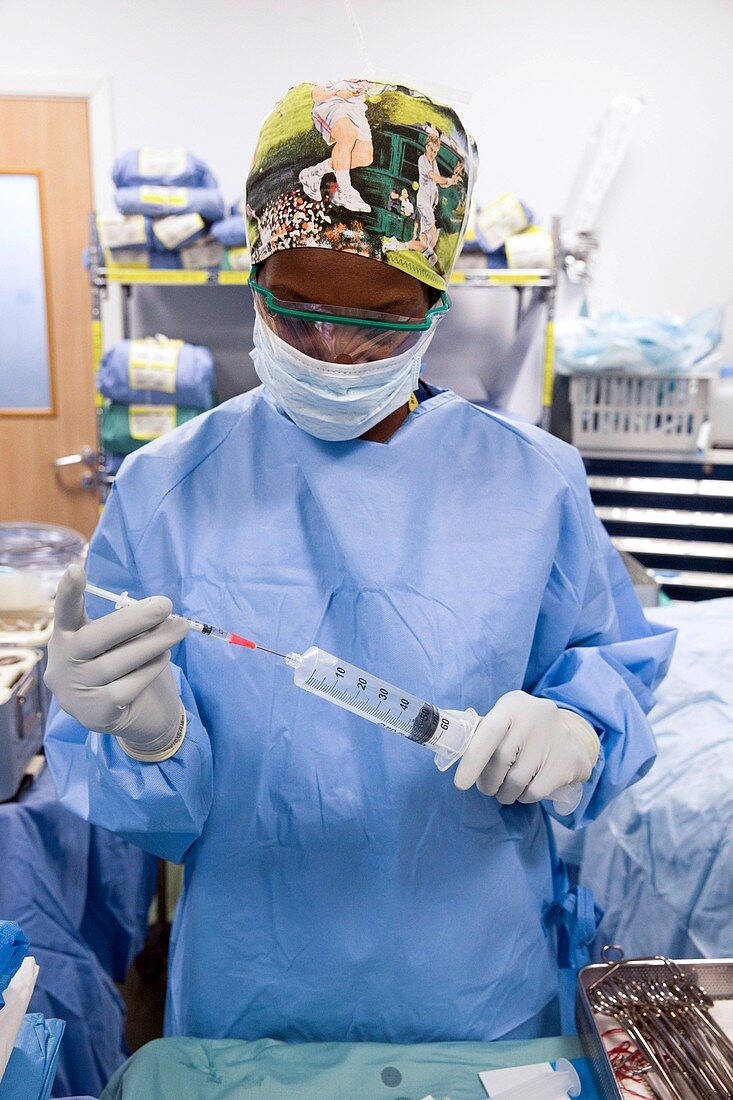 Surgeon preparing equipment
