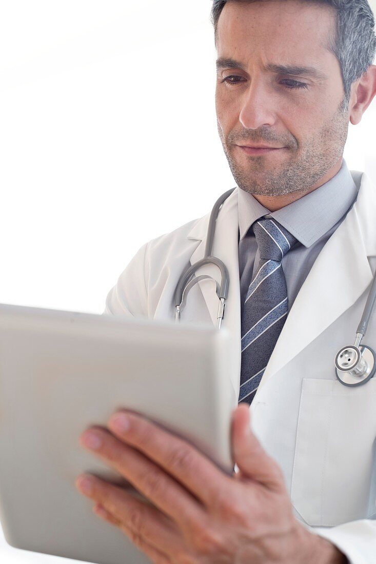 Male doctor using tablet