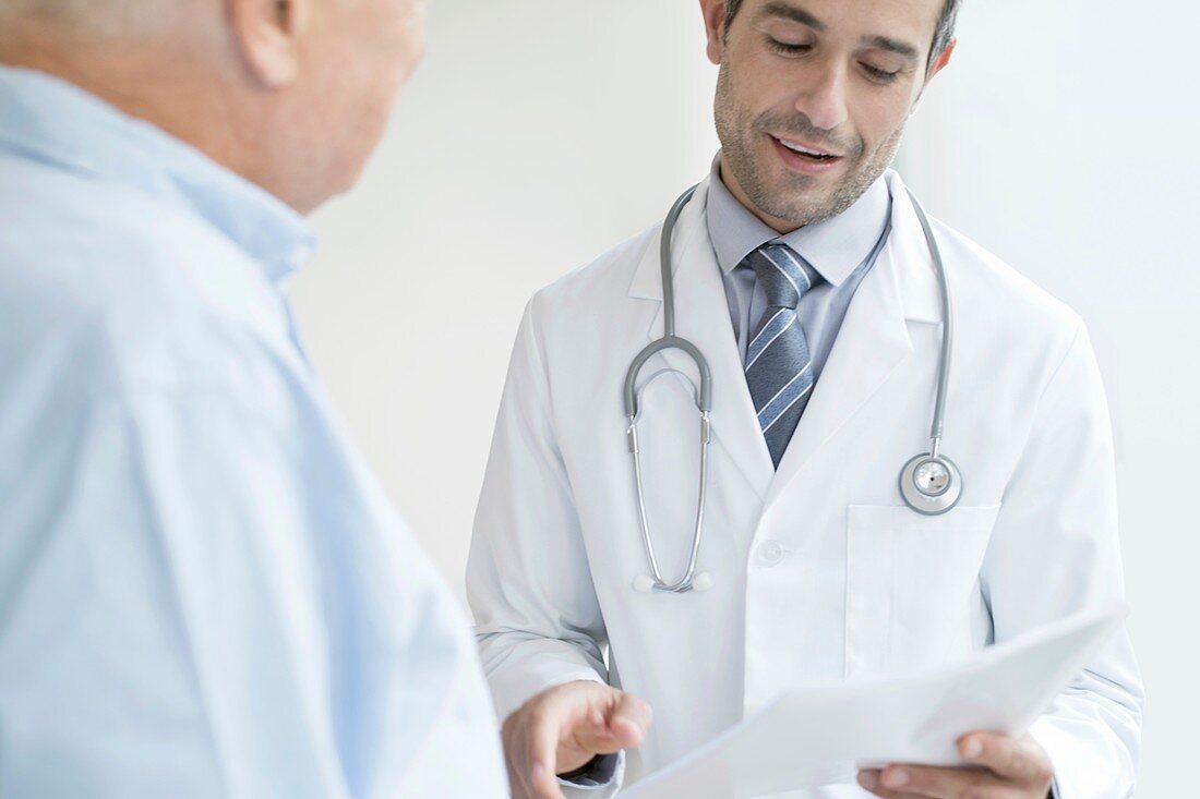 Male doctor holding medical notes