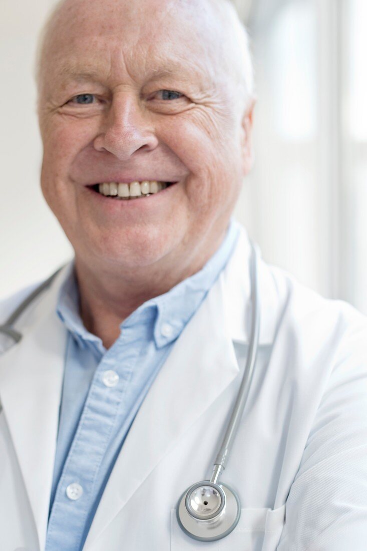 Senior male doctor smiling towards camera