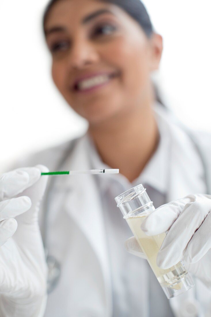 Female doctor testing urine