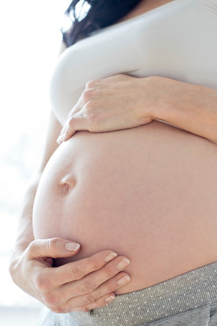 Pregnant woman touching tummy