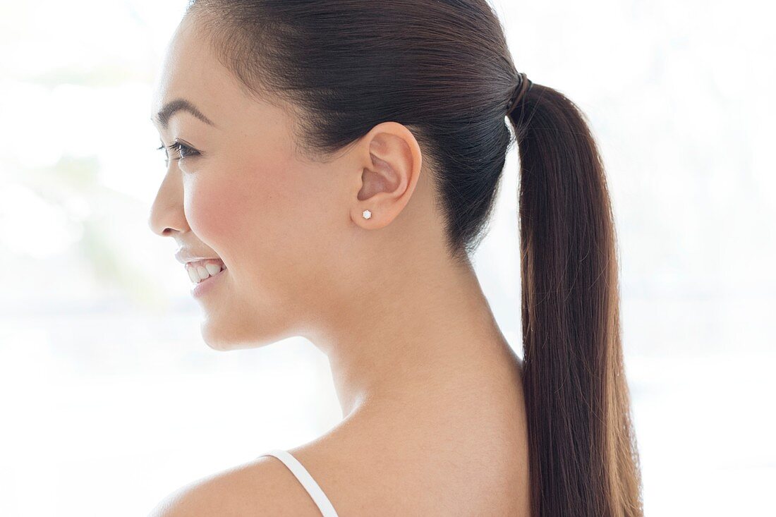 Woman with pony tail, smiling