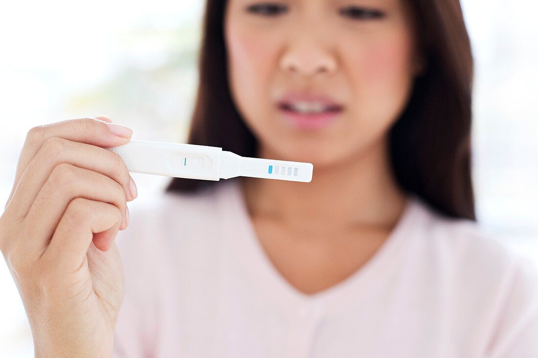 Woman holding pregnancy test