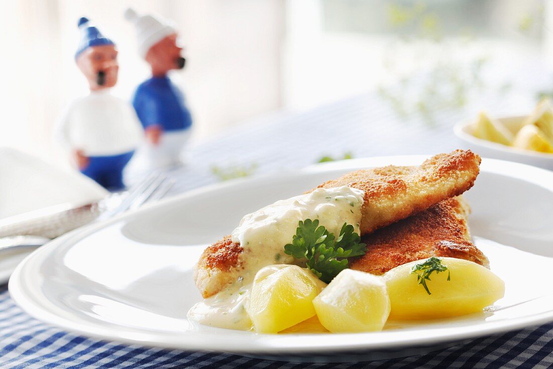 Fried fish with tartar sauce and boiled potatoes