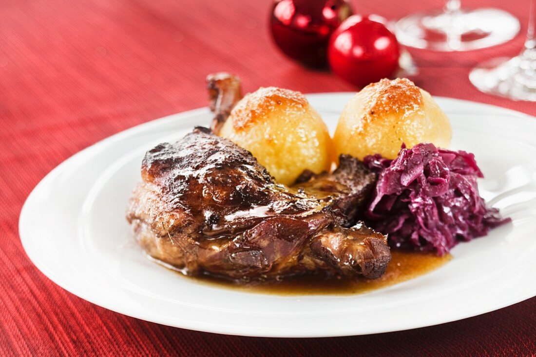 Goose leg with red cabbage and potato dumplings for Christmas