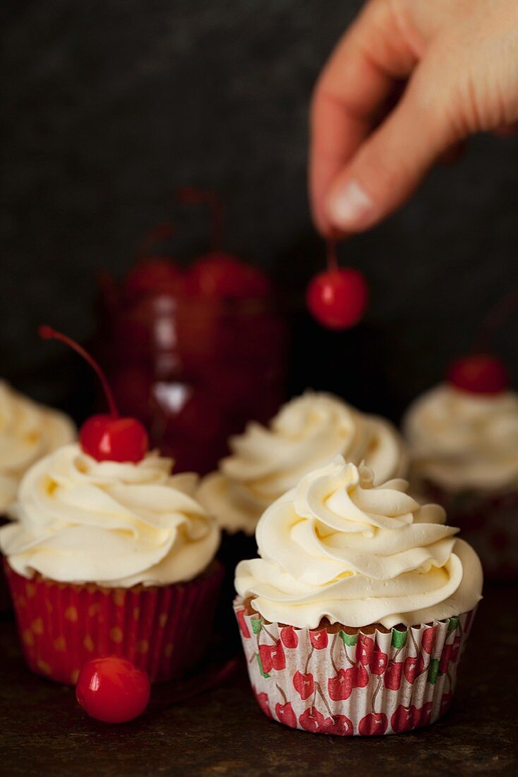 Decorating White Chocolate Cupcakes with Maraschino Cherries