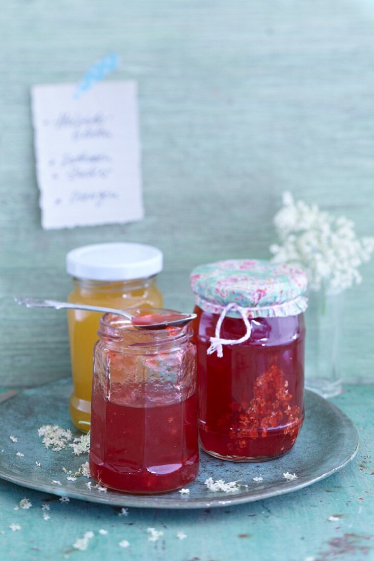 Fruit jam and elderflowers in glass jars