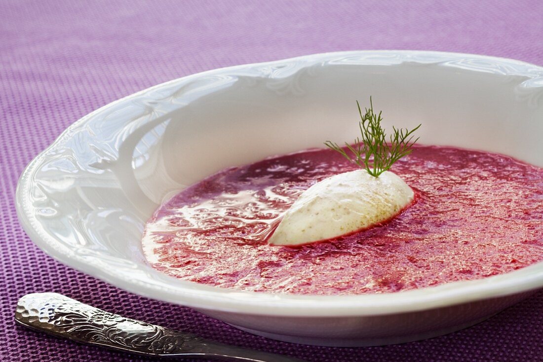 Beetroot soup decorated with a coconut quenelle
