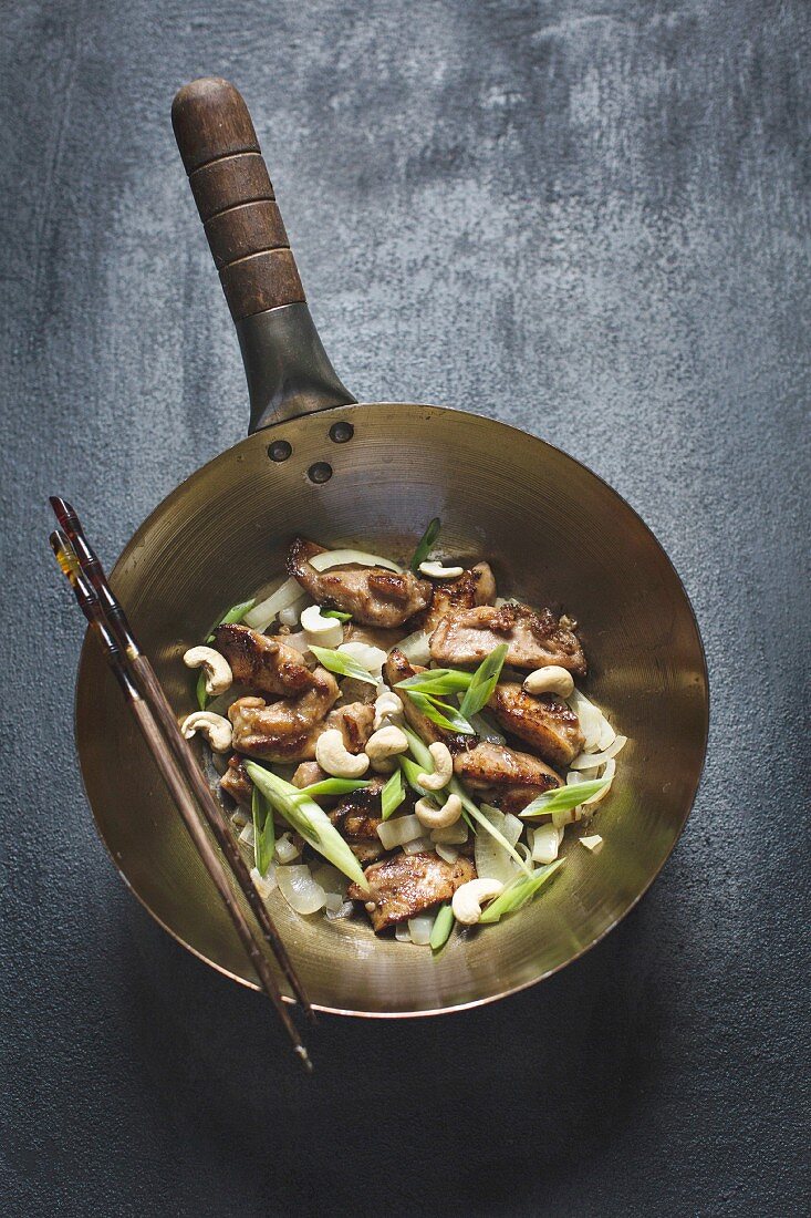 Chicken stir-fry with cashew nuts in a wok (Asia)