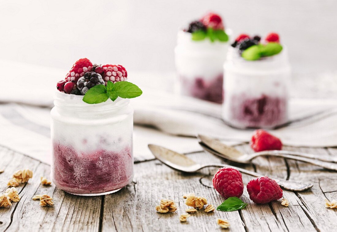 Homemade berry ice cream in screw-top glass jars