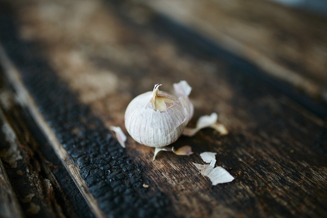 A mini bulb of garlic on a wooden background