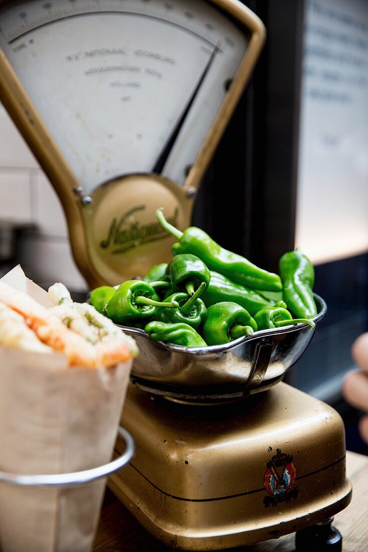 Pointed green peppers on scales