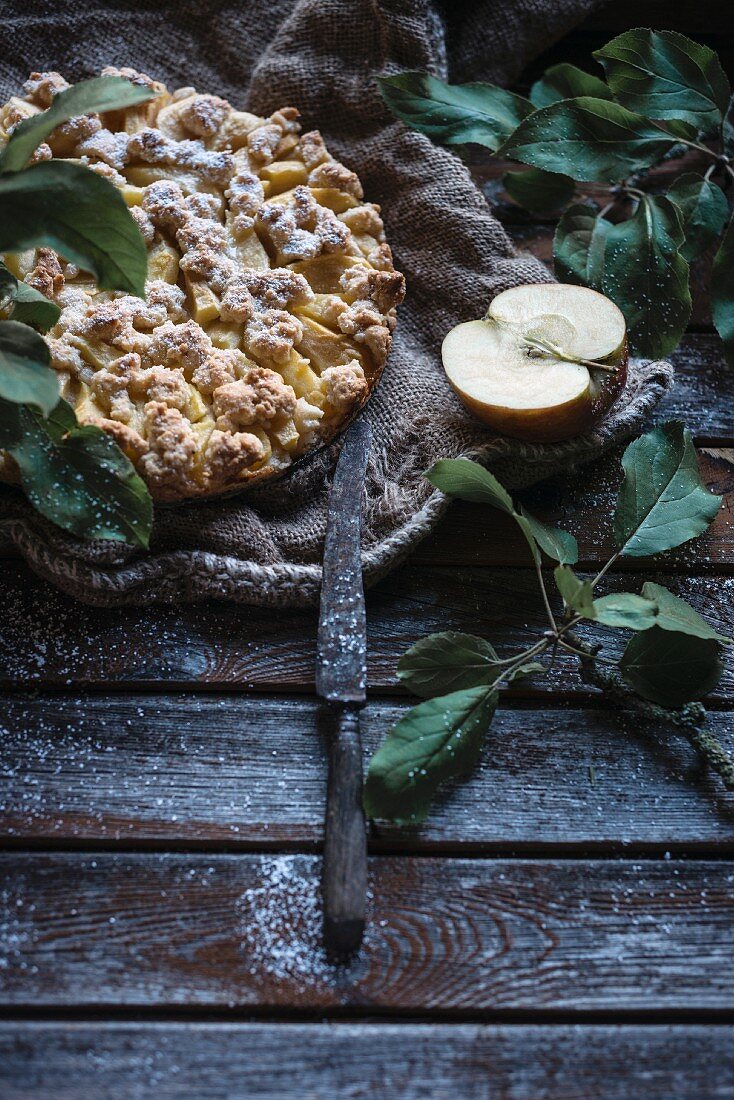 Vegan apple crumble cake on a rustic wooden background