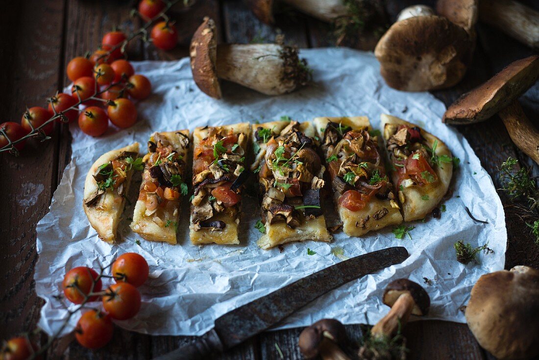 Vegan 'coca' (Spanish pizza) with wild mushrooms, tomatoes and onion