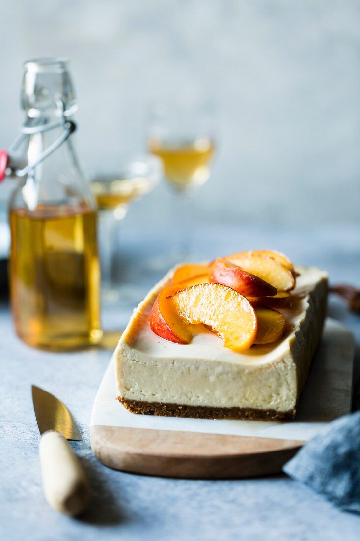 Gluten-free cheesecake with peaches in elderflower syrup
