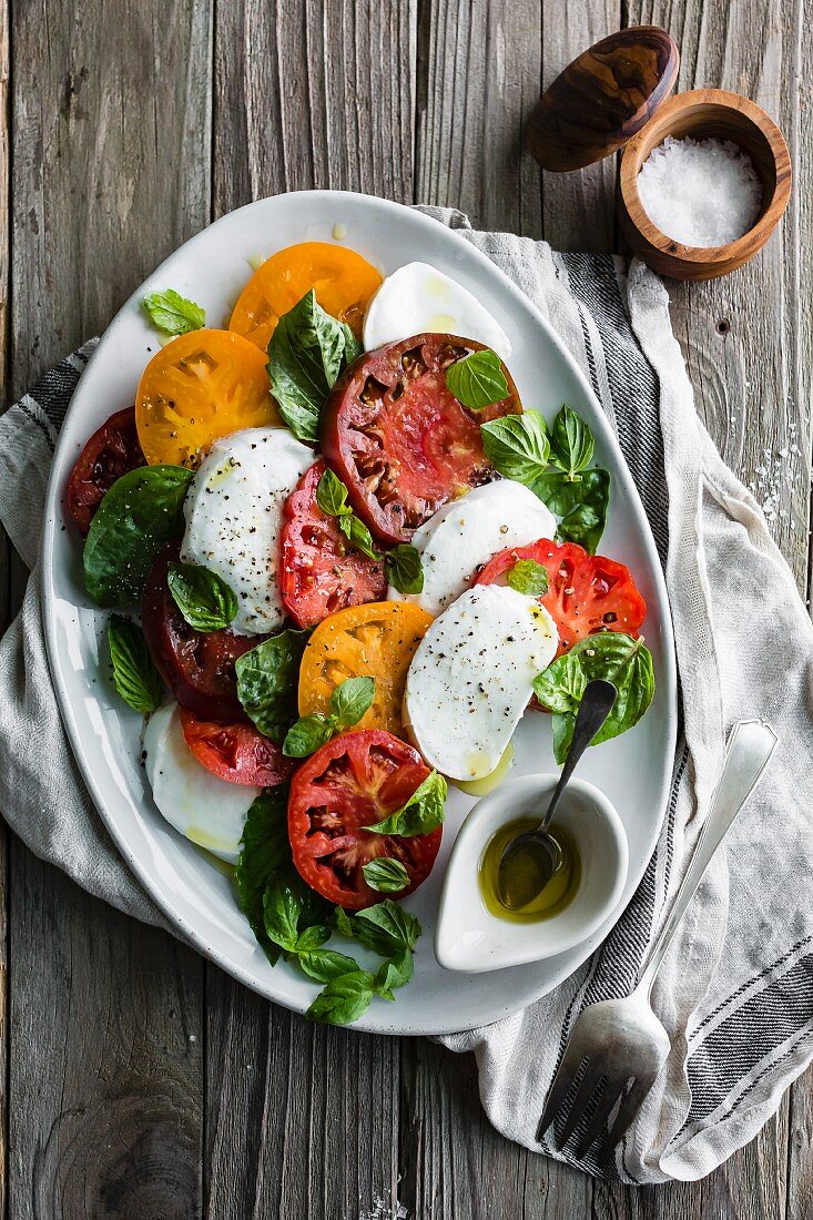 Caprese salad with red and yellow tomatoes (Italy)