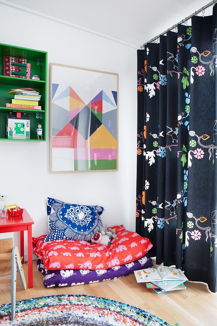 Blankets and cushions in cosy corner of child's bedroom