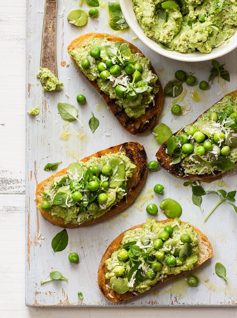 Broad bean and pea spread with basil and parmesan on toasted bread