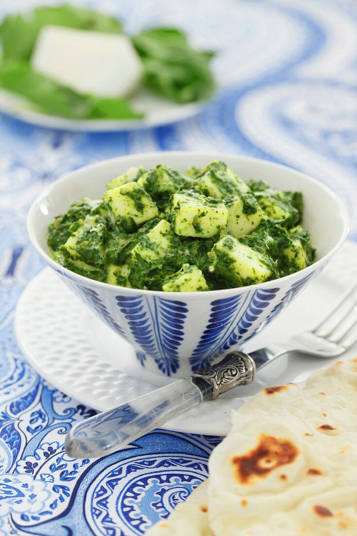 Spinach paneer in a blue and white dish