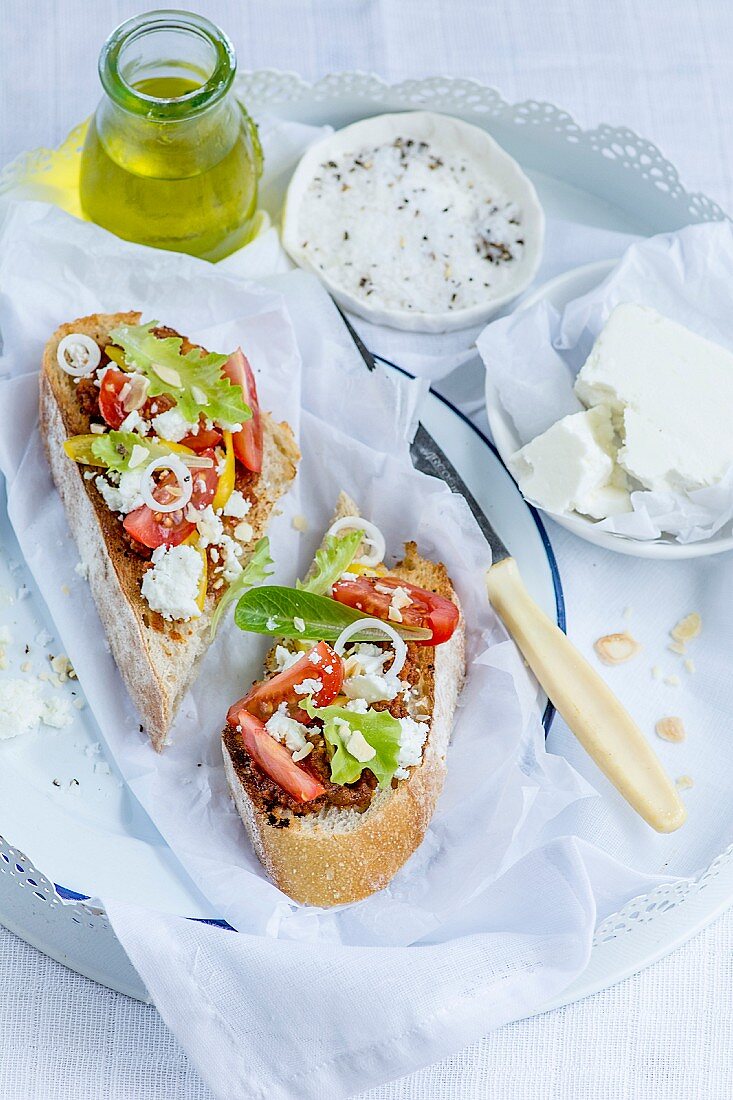Bruschetta with tomatoes, lettuce, olives, onion and feta