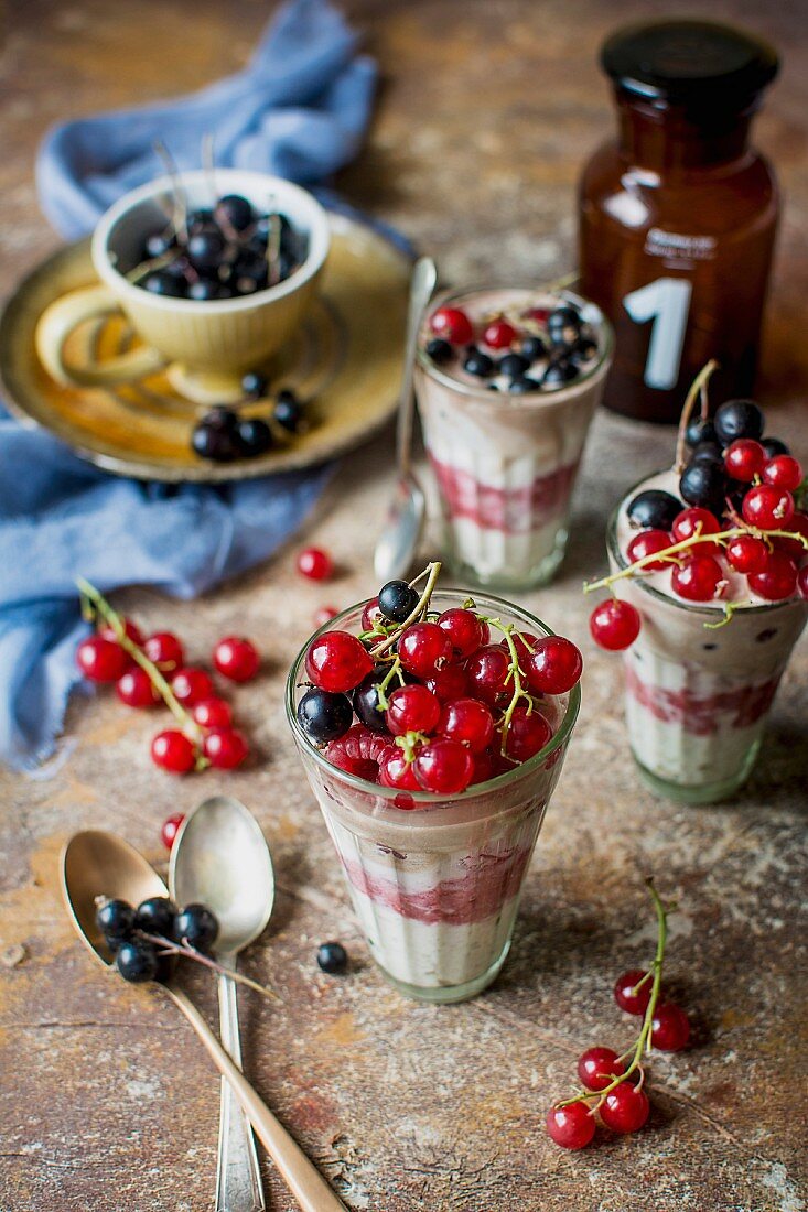 Layered yoghurt desserts with raspberries and redcurrants