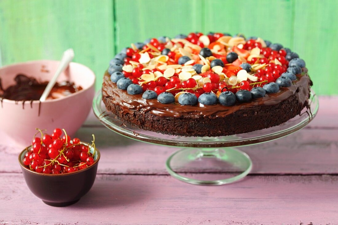 A sweet potato brownie cake with berries and flaked almonds