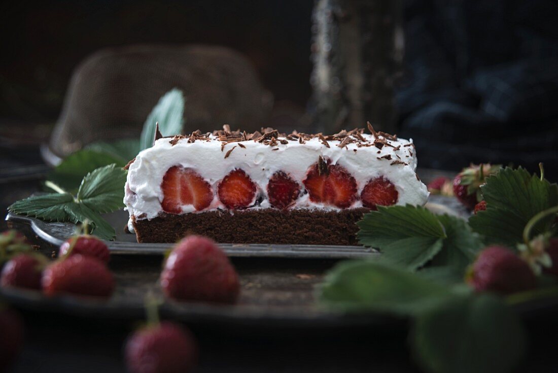 Vegan chocolate cake with strawberries and cream
