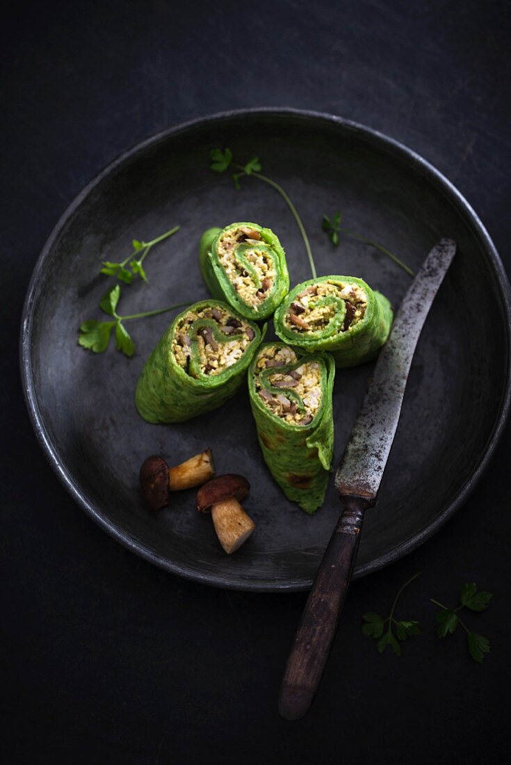 Vegan spinach pancake with scrambled tofu and wild mushroom filling