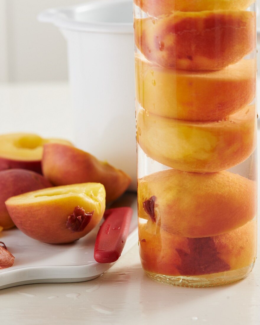 Peaches preserved in a glass