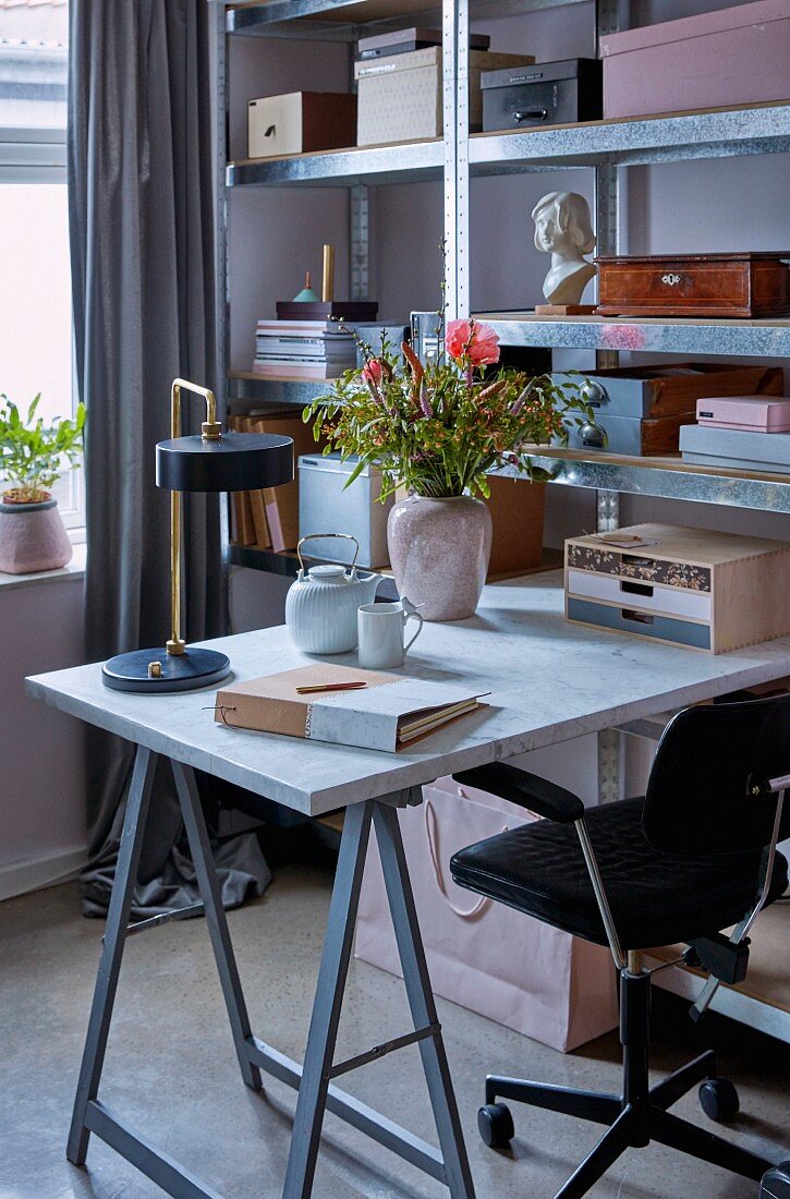 Desk on trestles and storage boxes on metal shelving