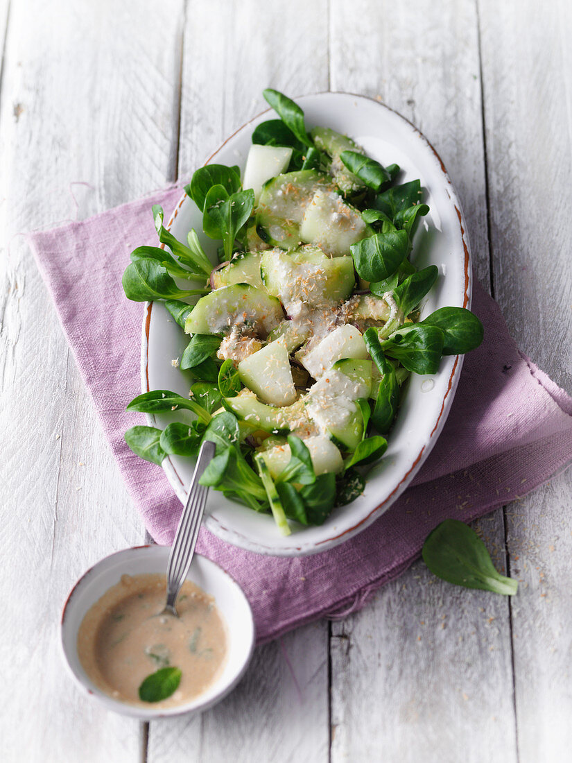 Honeydew melon salad on lamb's lettuce with a coconut dressing