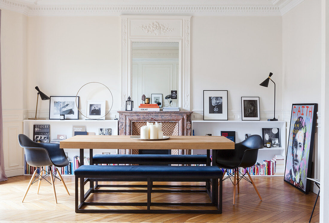 Modern dining table and upholstered benches in front of open fireplace