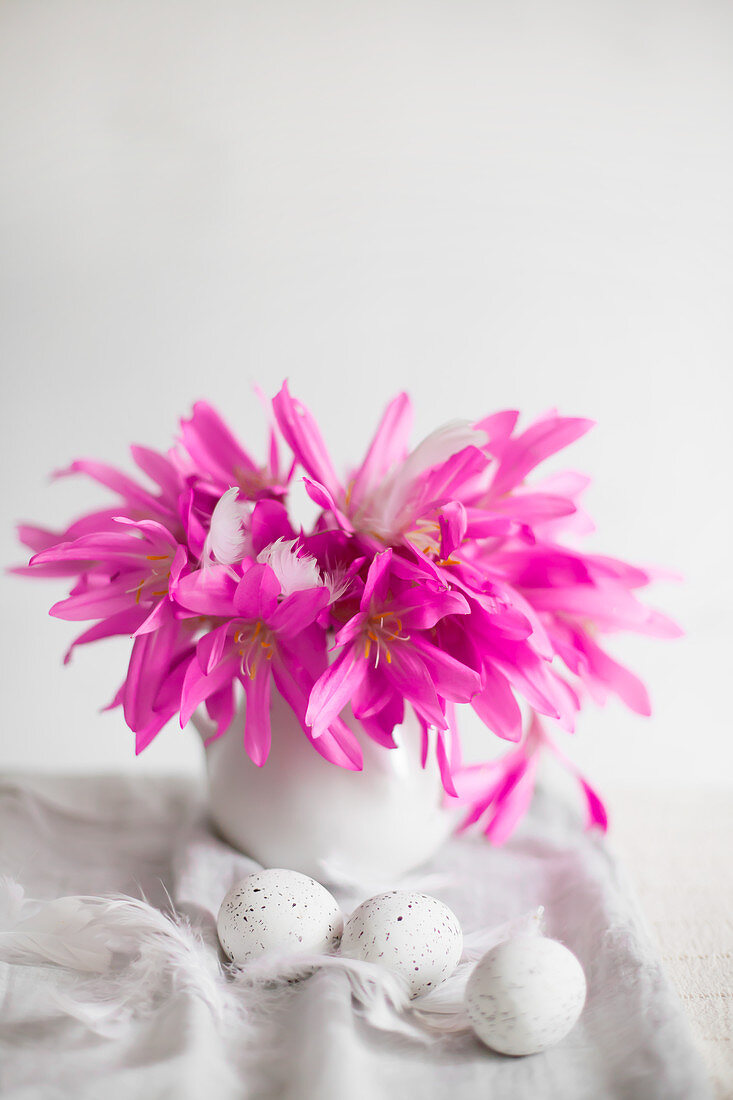 Vase of spring meadow saffron flowers and speckled eggs