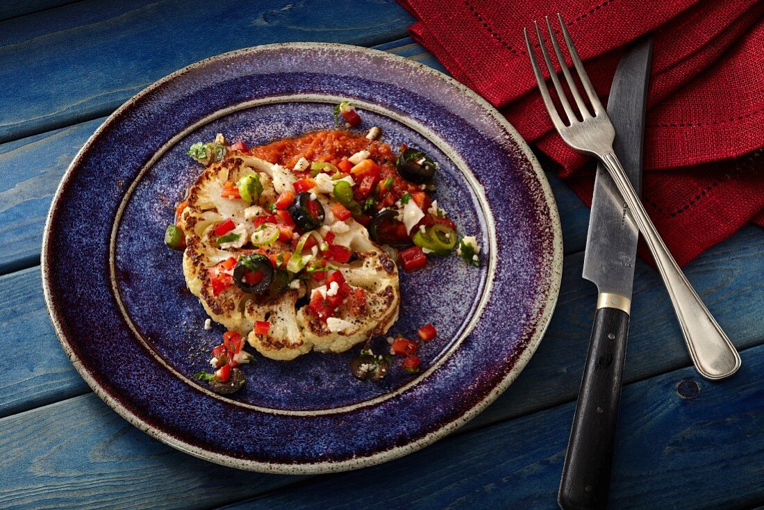 Cauliflower steak with olives and red pepper