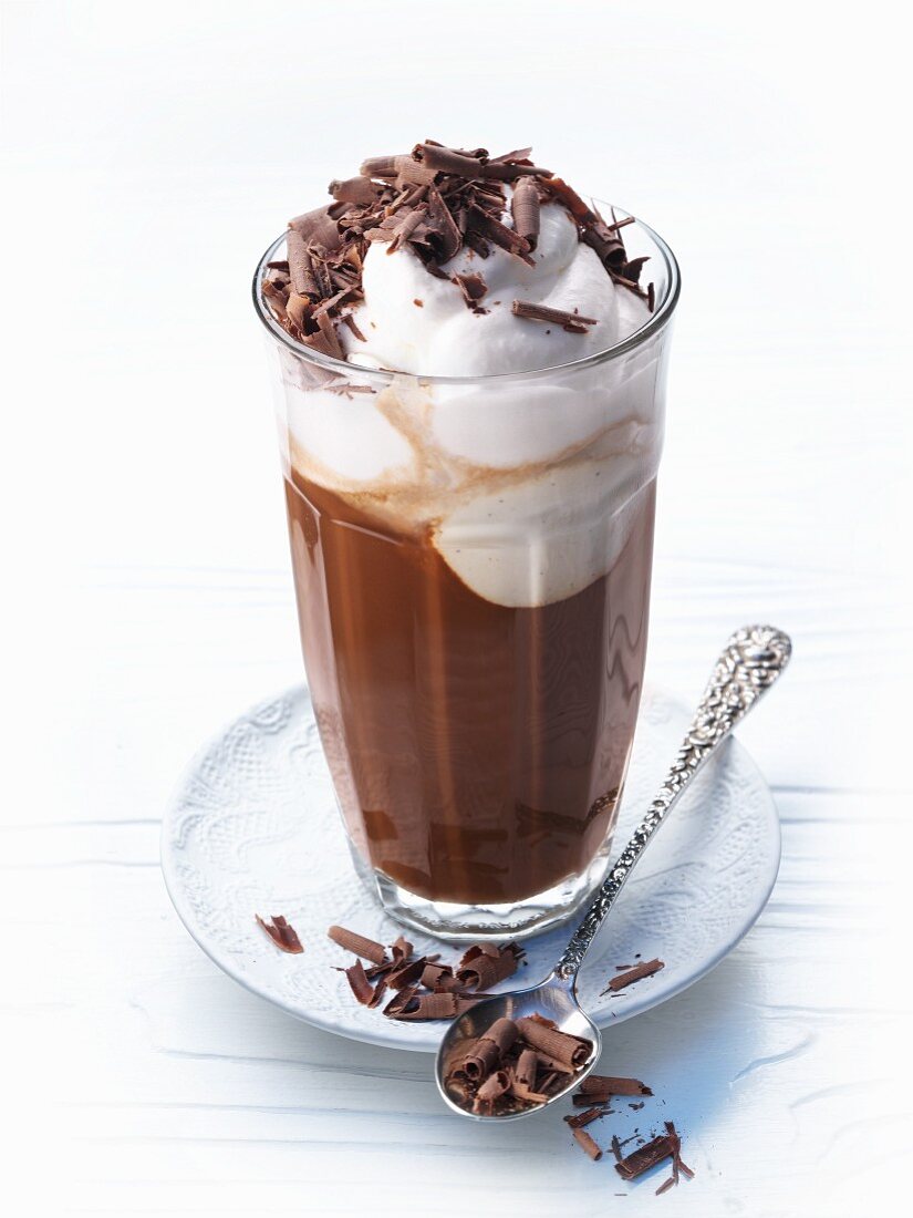 Hot chocolate in a glass with cream and chocolate shavings