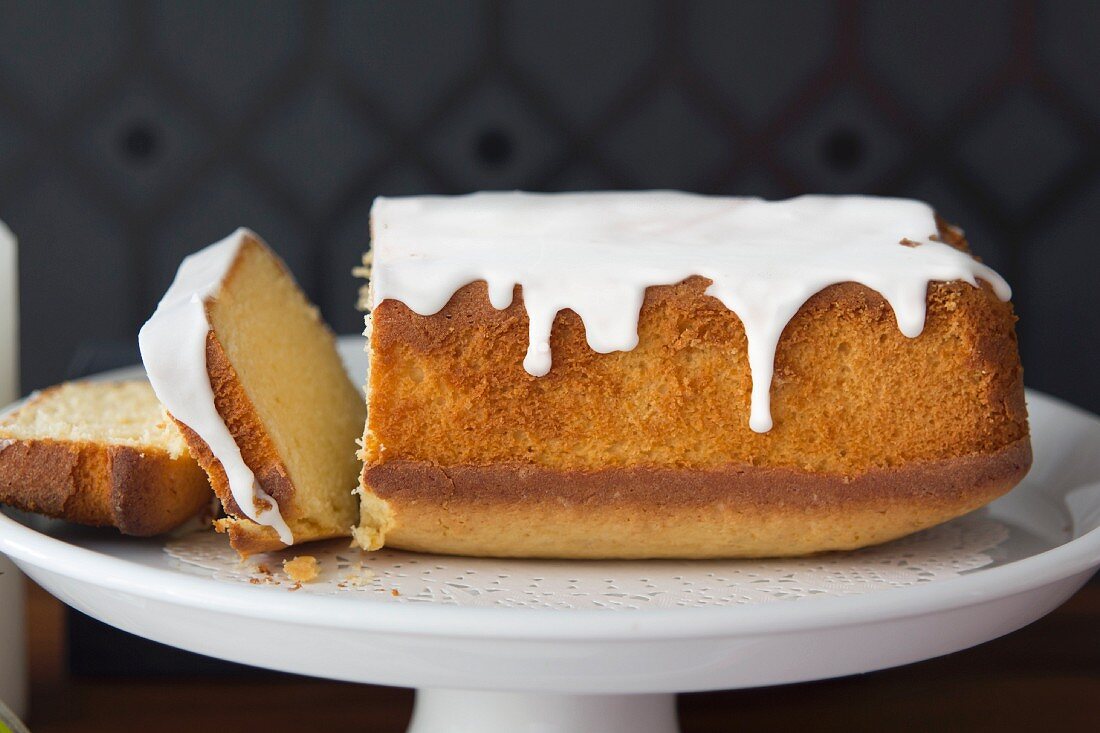 Slices cut off a pound cake with vanilla icing
