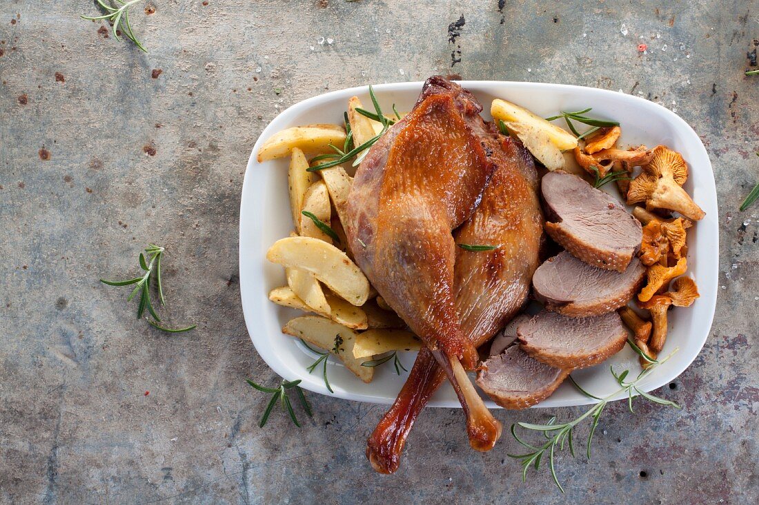 Goose legs and breast with chanterelle mushrooms and roast potatoes