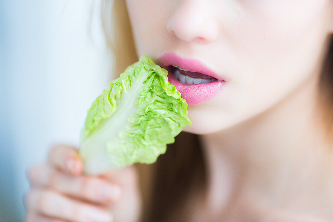 Woman eating lettuce