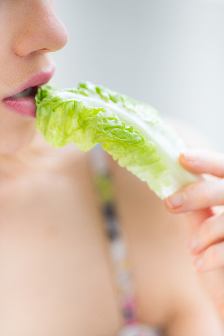 Woman eating lettuce