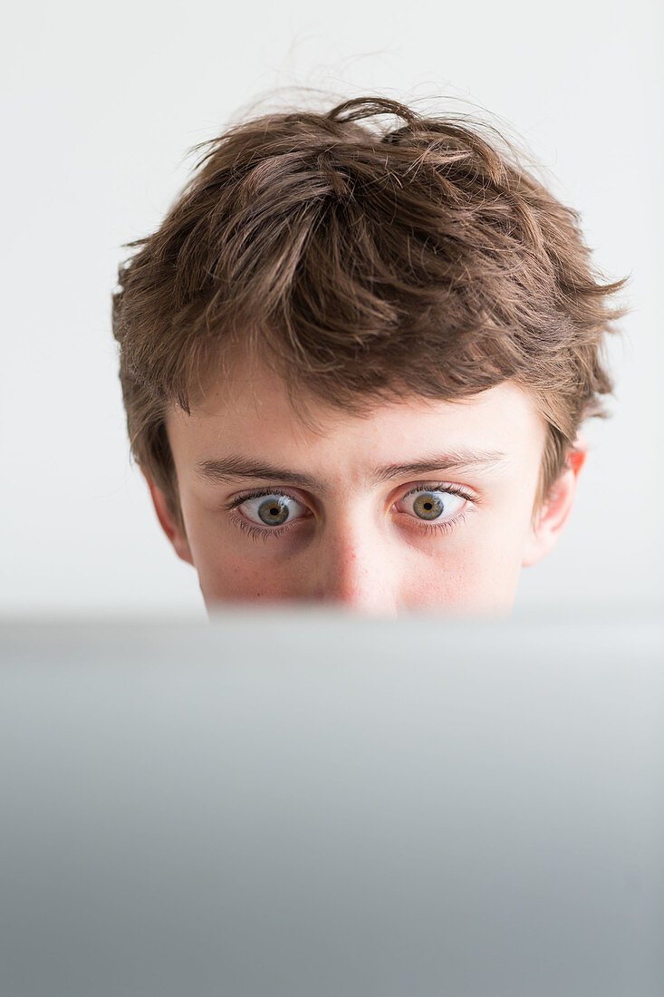 Teenage boy using laptop computer