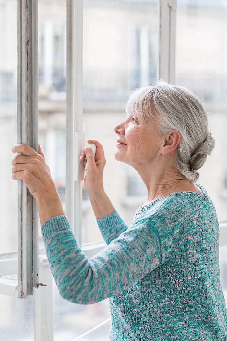 Woman opening window