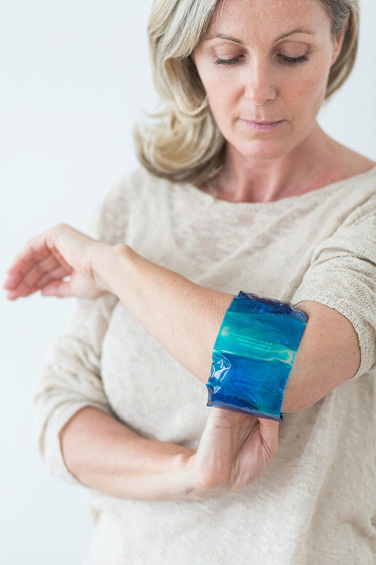 Woman using a hot-cold gel pack